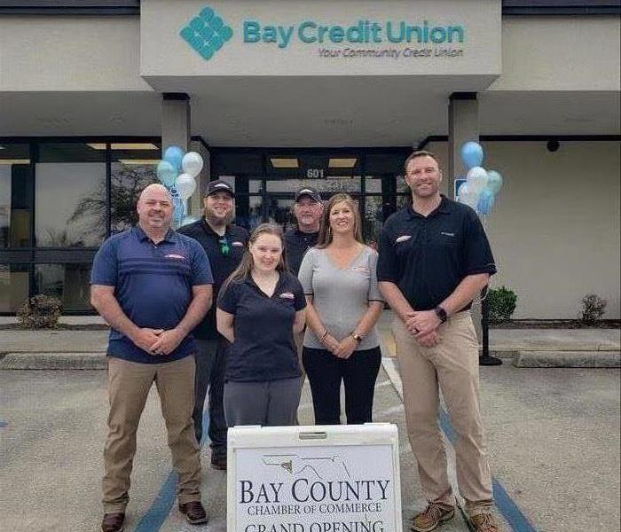 SERVPRO employees standing in front of a newly reconstructed bank in Panama City, Florida