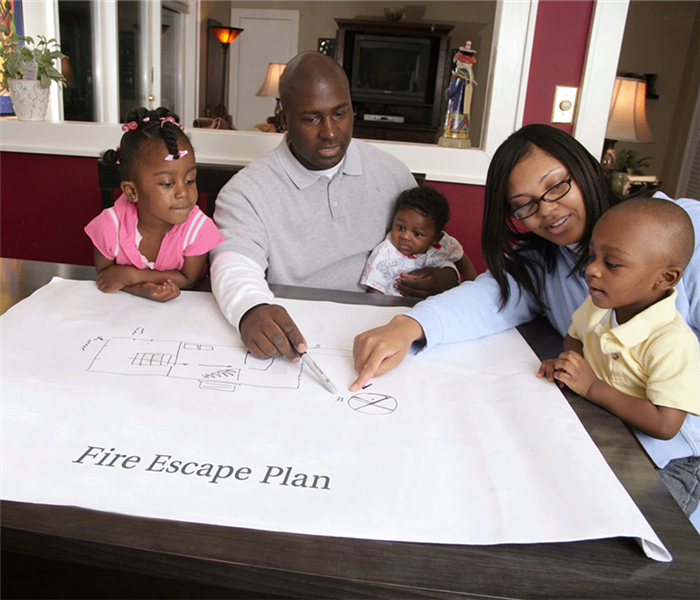 Family reviewing a fire evacuation plan