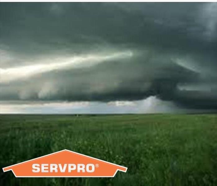 Storm Clouds over a field with SERVPRO logo